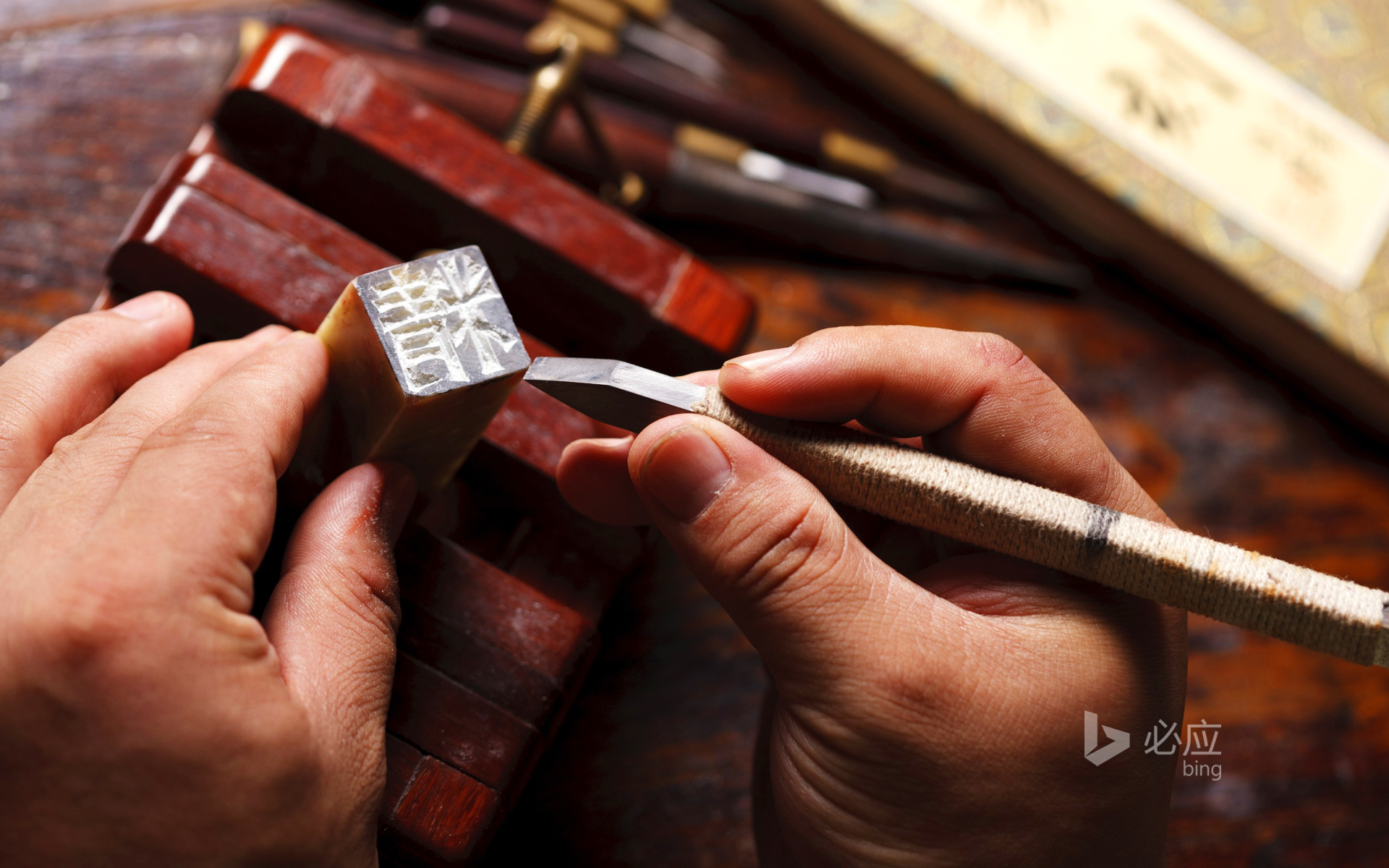 Craftsman is carving Chinese character seal