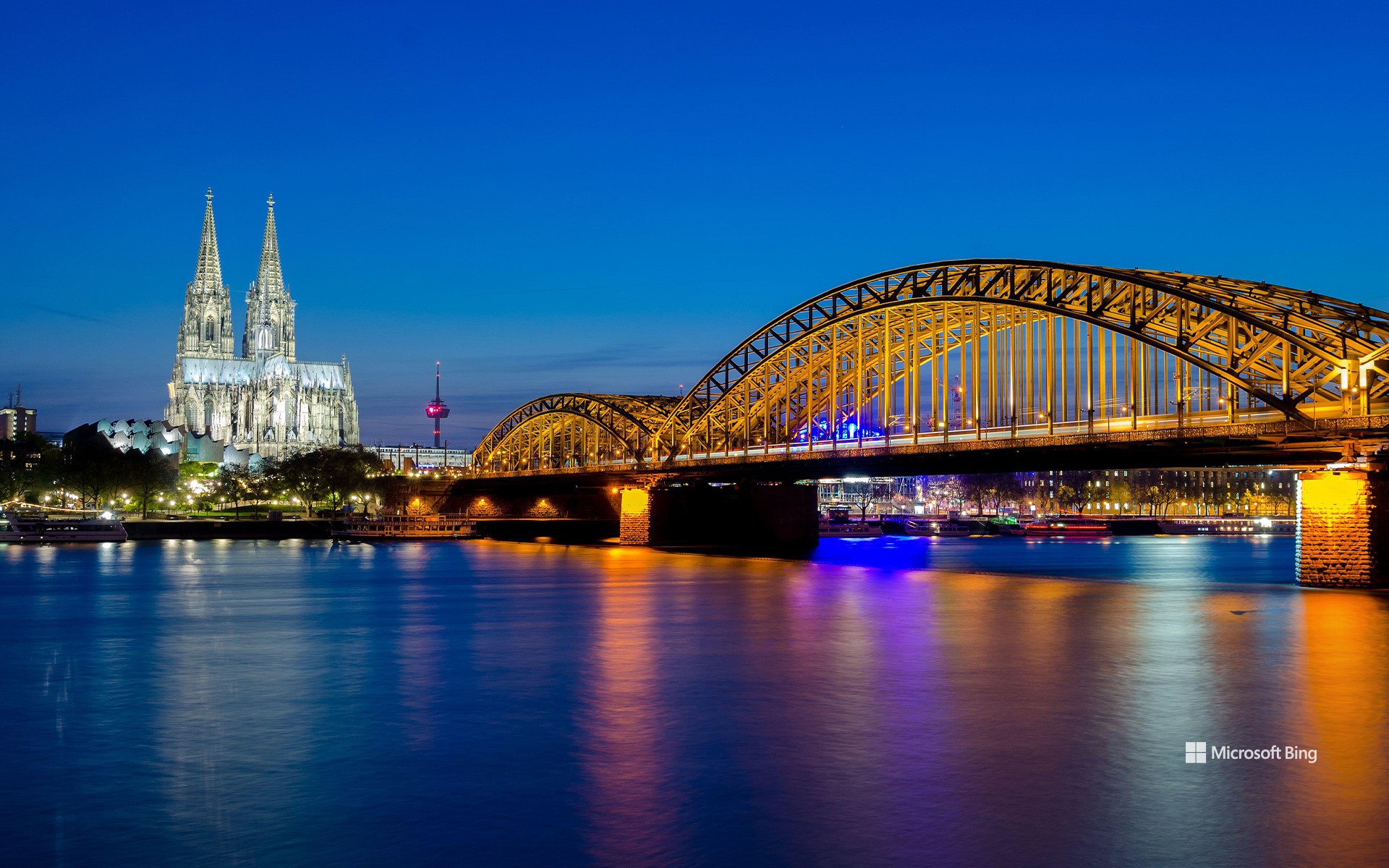 Hohenzollern Bridge with Cologne Cathedral and the Rhine at sunset in Cologne