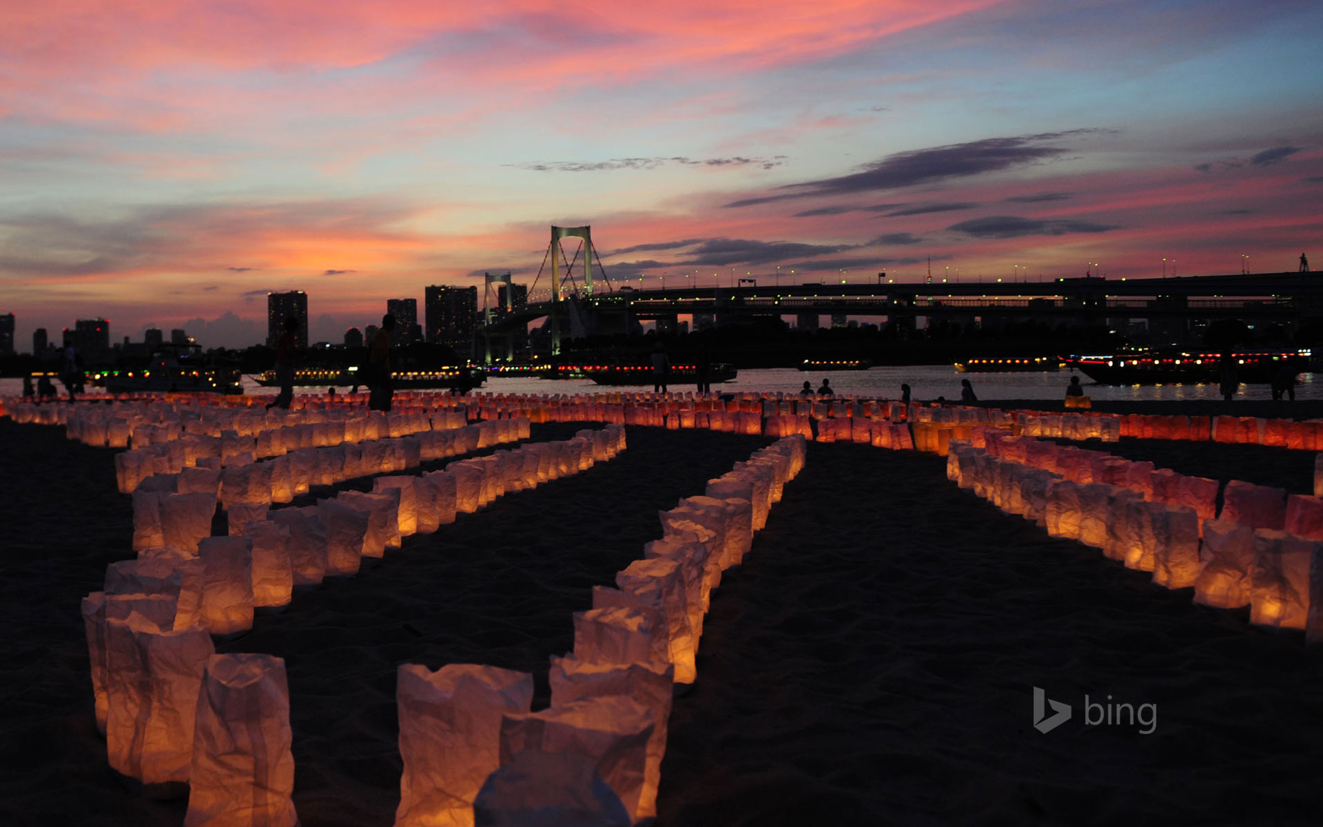 Candles line the beach at Odaiba Marine Park for Marine Day, Tokyo, Japan