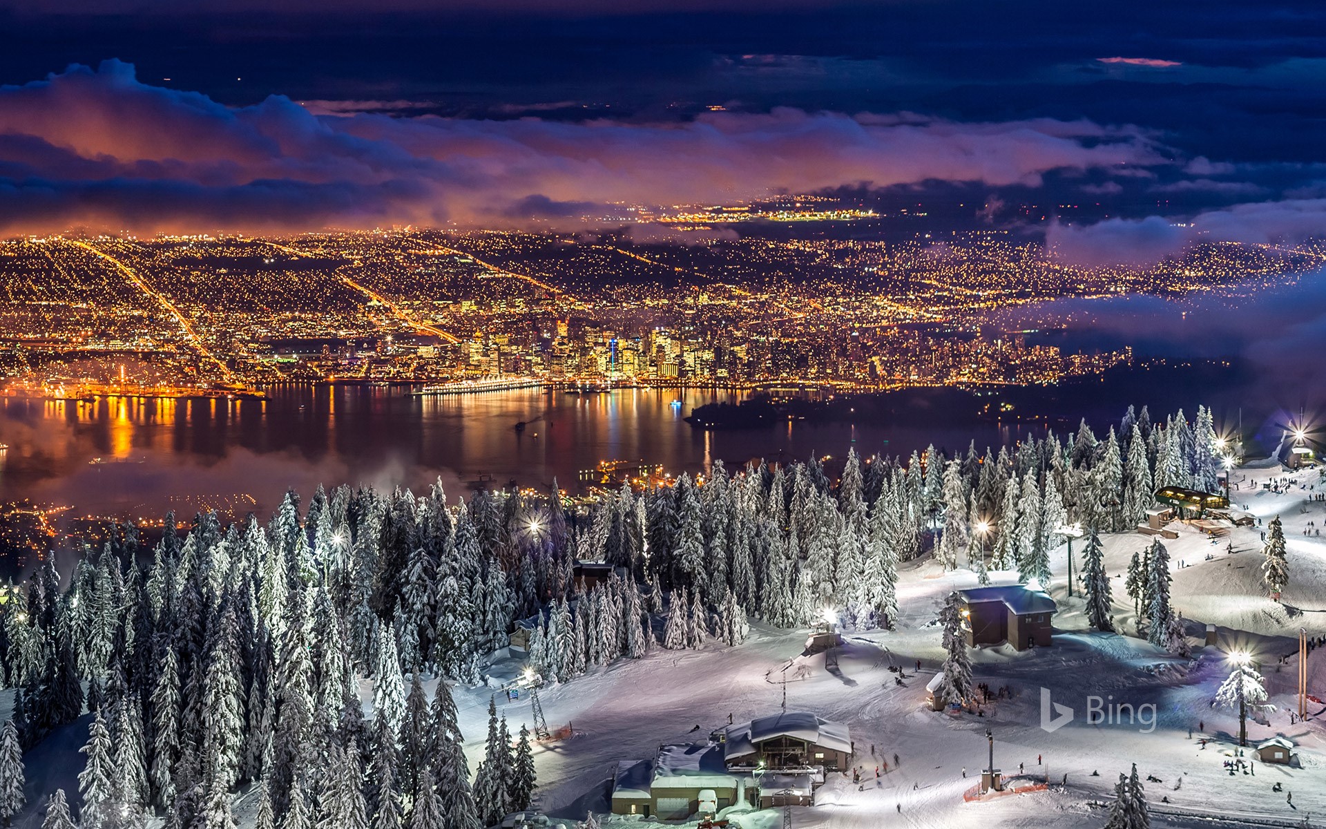 City lights from the snowy peak of Grouse Mountain at twilight, Vancouver, BC, Canada