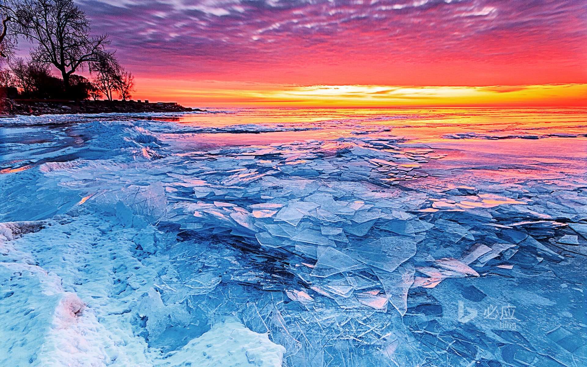 Ice and fire, rising sun over frozen Lake Erie