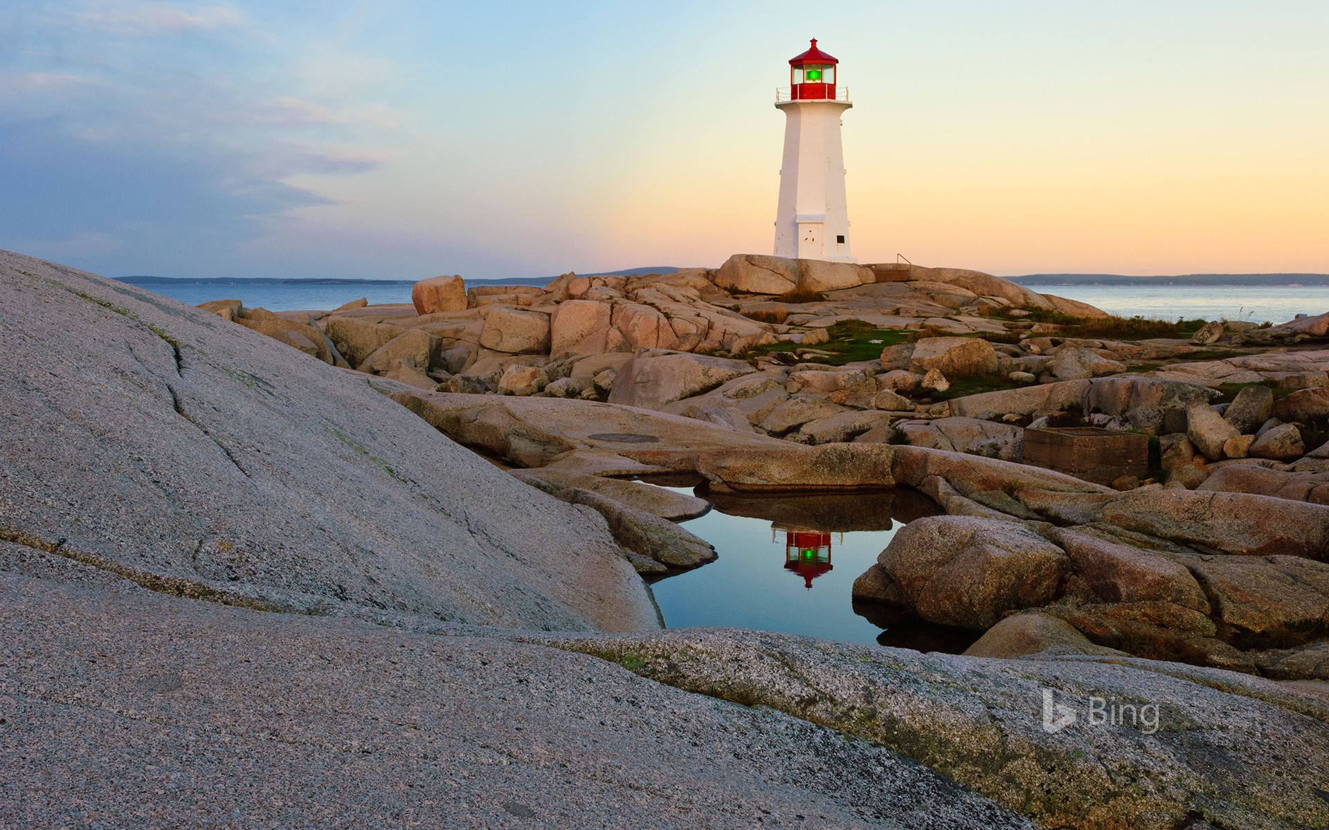Lighthouse reflected in a pool of water at Peggy's Cove, Nova Scotia, Canada
