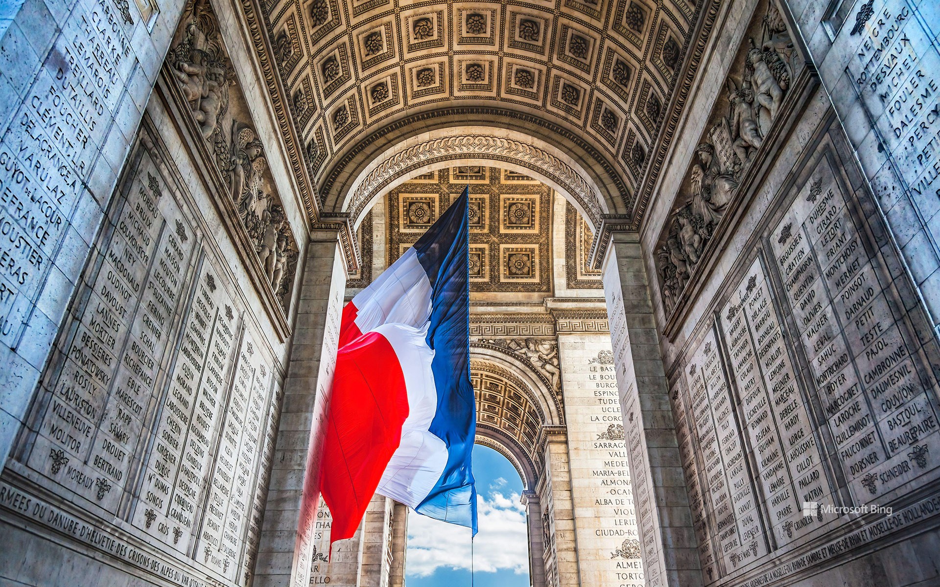 French flag under the Arc de Triomphe, Paris, France