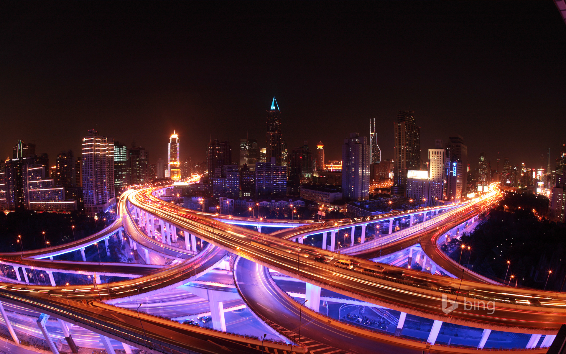 Shanghai's roadways and skyline lit up at night