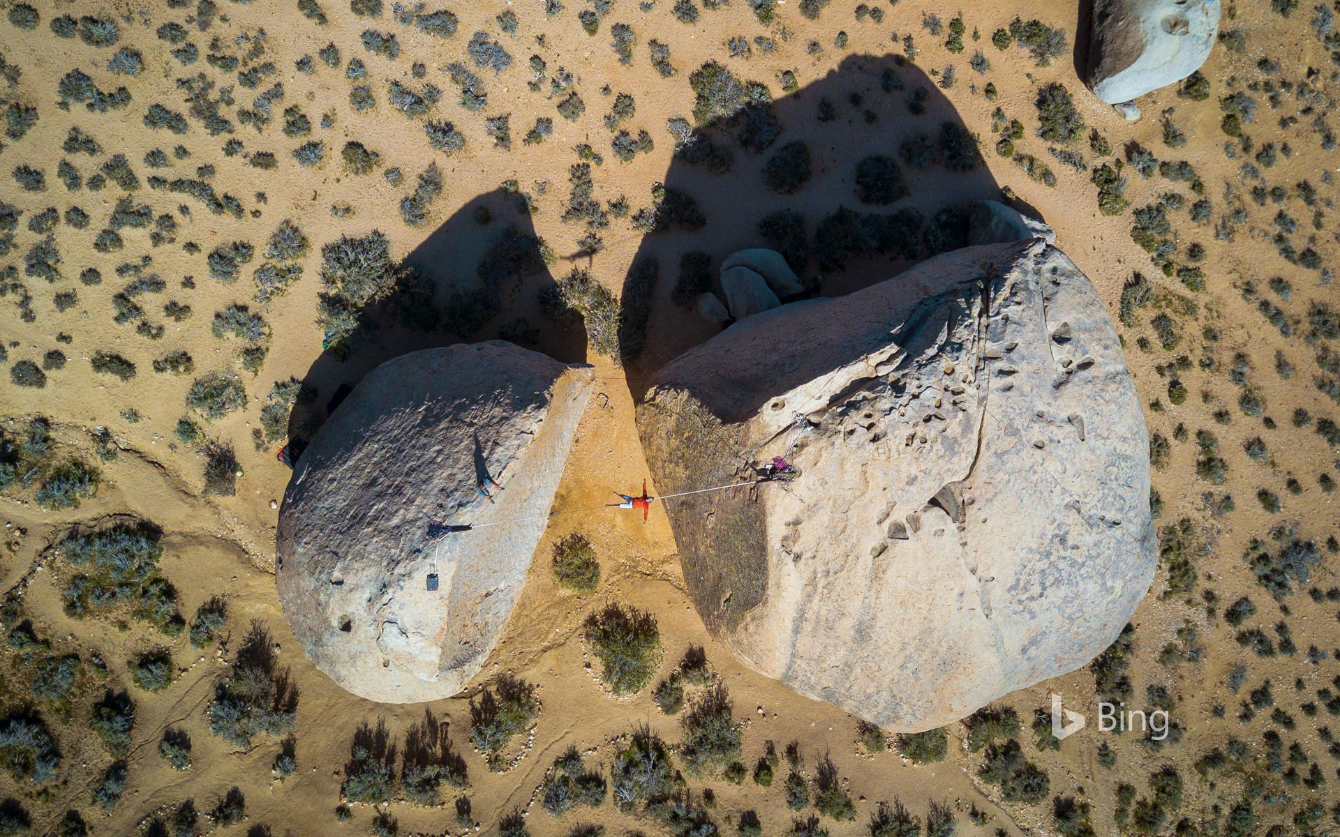 Slacklining between giant boulders in Bishop, California