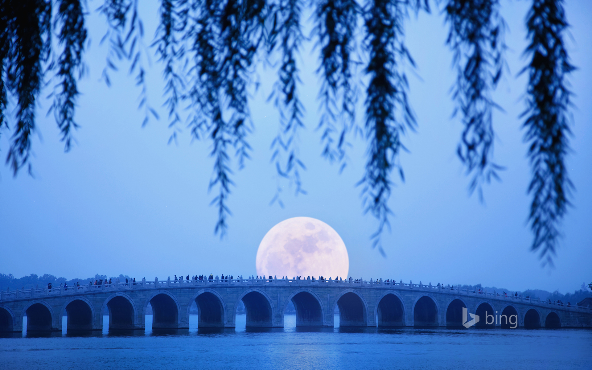 Moonrise over Seventeen Arch Bridge on Kunming Lake at the Summer Palace in Beijing, China