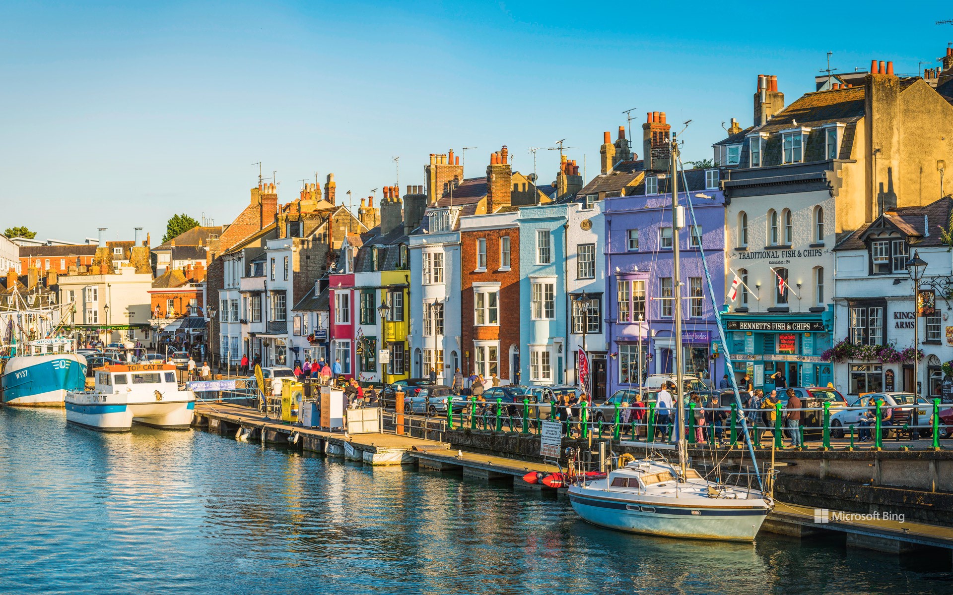 Colourful cottages, fishing boats and yachts around the harbour in Weymouth, Dorset