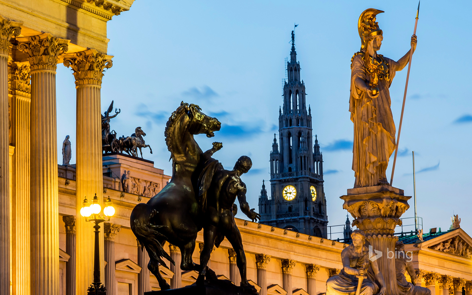 View to parliament building, town hall tower and statue of goddess Pallas Athene by twilight, Vienna, Austria
